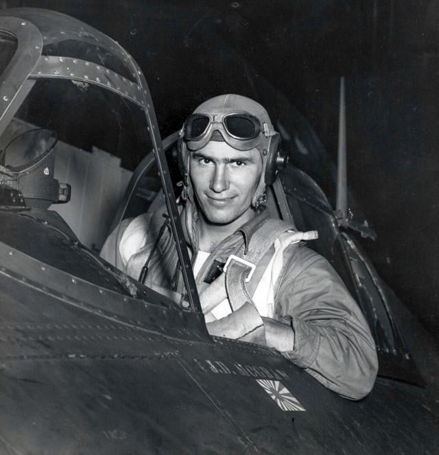 Ensign Joseph McGraw seated in the cockpit of a Wildcat fighter aircraft