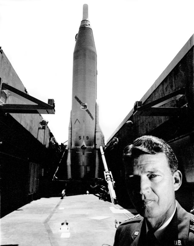 Composite of Gen. Bernard Schriever posing in front of an Atlas missile.