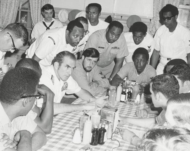 Admiral Zumwalt (third from left), shown speaking with the Human Relations Council at Fleet Activities, Yokosuka, Japan, was committed to improving the lives of all sailors to increase reenlistment. He did so by issuing “Z-Grams” directly to the fleet, which eased some restrictions on junior sailors, improving barracks, and implementing several other programs.
