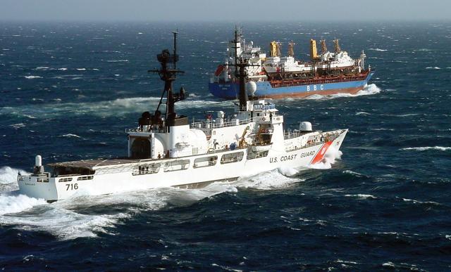 The USCGC Dallas (WHEC-716) escorts the M/V BBC Spain, carrying four Island-class 110-foot patrol boats to join Patrol Forces Southwest Asia in March 2003.