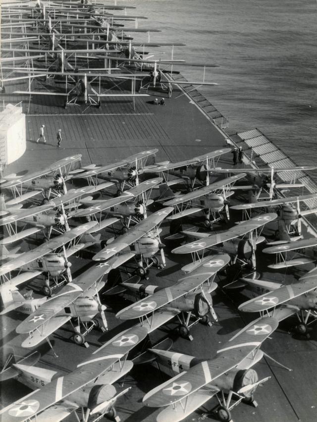 The USS Lexington (CV-2) embarked with Martin T4M-1 torpedo planes, Curtiss F6C-3 fighters, and Boeing F3B-1 fighters for Fleet Problem IX