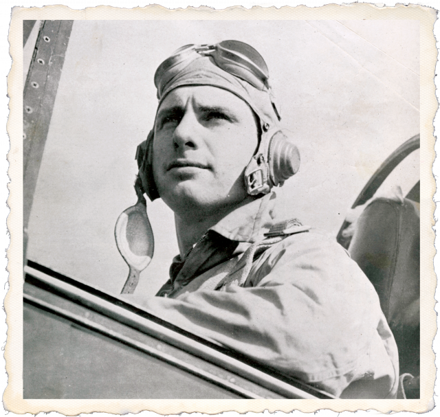 Joe Hunt sitting in an aircraft cockpit wearing flight gear