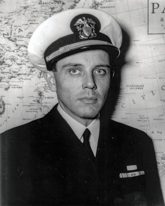Portrait of Robert W. Copeland standing in front of a map