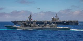 The Nimitz-class carrier USS Ronald Reagan (CVN-76) and Japan Maritime Self-Defense Force destroyer Samidare steam in formation in the western Pacific. Dependence on other navies for sea-lane defense is a force multiplier and is the basis for Japan Maritime Self-Defense Force doctrine. 