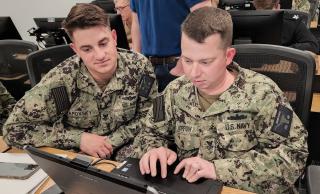 Two sailors participate in “Scrip-to-thon,” a three-day event that brought together cryptologic technicians network and information systems technicians. Starting this year, the Navy will be converting many ITs and all CTNs to the new cyber  warfare technician rating.
