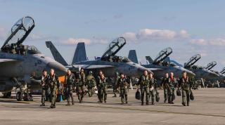 Navy EA-18G Growler pilots walk down the flightline during a homecoming ceremony  at Marine Corps Air Station Iwakuni, Japan. Pilot production took a major hit in 2022–23  because of a widespread T-45C grounding, and pilot retention remains an issue.  