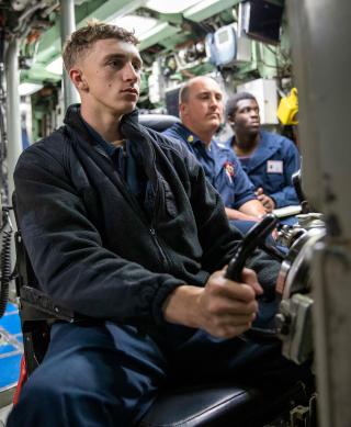 Sailors assigned to the USS Annapolis (SSN-760) stand watch in the control center in January 2023. It is imperative to improve sleep management guidance for the Navy—much as the submarine community already has.  