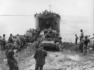 Squarepeg’s D-Day landings on Nissan Island were virtually flawless, with Kiwis and their equipment disembarking and being unloaded from sequentially arriving waves of landing craft and ships. Above: U.S. sailors and New Zealand soldiers watch as a Mk IIICS Valentine tank rumbles ashore from LST-446. 