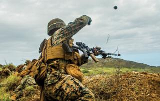 A Marine from 3d Battalion, 3d Marines (3/3), throws a grenade