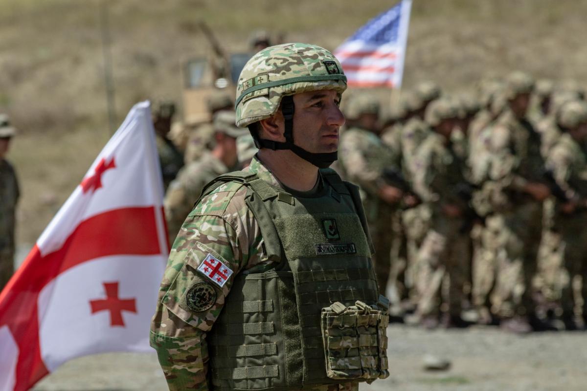 Military personnel from Georgia and the United States stand in formation during the closing ceremony of Agile Spirit 19 at Orpholo Training Area, Georgia, in August 2019. Personnel from 14 countries participated in the Georgia-NATO exercise.