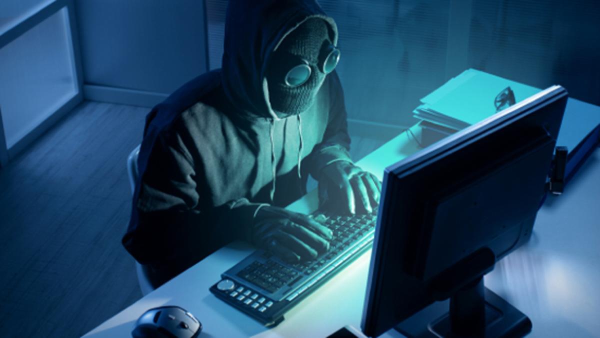 Masked hacker at a computer