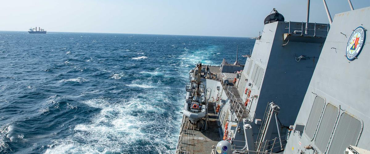 The USS Gravely (DDG-107) escorts a merchant vessel through Bab al-Mandeb on 12 January. 