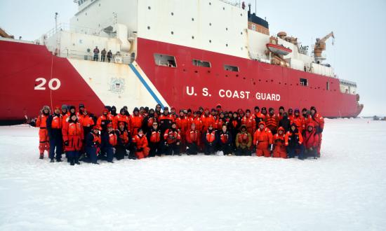 Coast Guard Cutter Healy (WAGB-20) crewmembers and scientists pose for a group photo during Healy’s first ice station while deployed to the Arctic Ocean in 2019.