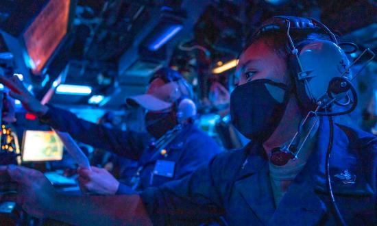 Sailors monitor surface contacts from the combat information center aboard the USS John S. McCain (DDG-56)