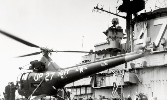A Sikorsky HO3S-1 helicopter rests on the carrier USS Philippine Sea (CV-47) during the Korean War. These helicopters were flown in large numbers during the conflict for VIP and mail delivery, search and rescue, gunfire spotting—and mine-spotting.