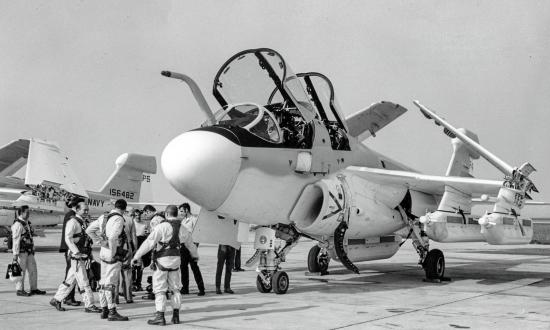 Ground-to-ground left front view of an EA-6B Prowler with crew standing outside