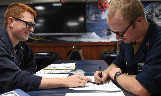 Sailors on board the USS Philippine Sea (CG-58) fill out paperwork for absentee voting. Nothing shows you care about the voice of your sailors more than encouraging them to vote.