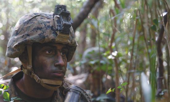 A U.S. Marine scans the area at the Jungle Warfare Training Center (JWTC), Camp Gonsalves, Okinawa, Japan, on Mar. 12, 2019