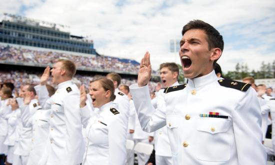 U.S. Naval Academy midshipmen take the oath of office to become Navy officers during the graduation and commissioning ceremony