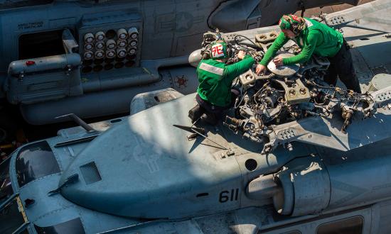 Sailors from Helicopter Sea Combat Squadron Six perform maintenance on an MH-60S Seahawk helicopter while deployed on board the USS Nimitz (CVN-68) in the western Pacific.  