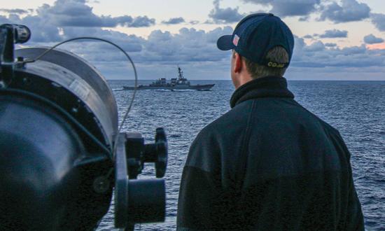 An ensign stands watch on board the USS Ross (DDG-71). While recent changes to junior surface warfare officer training were designed to emphasize bridge watchstanding, they do not address the problem of too many ensigns assigned to each ship.