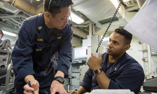 Chief Gas Turbine System Technician (Mechanical) Seung Song gives instructions to Lieutenant (junior grade) Ramon Cortes during engineering training team drills on board the USS Farragut (DDG-99).