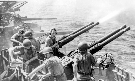 A gun crew on board the USS Hornet (CV-12) fires its quad-mount Bofors 40-mm in 1945