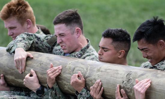Midshipmen holding a log