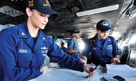 Enlisted personnel at a chart table on the bridge of a ship