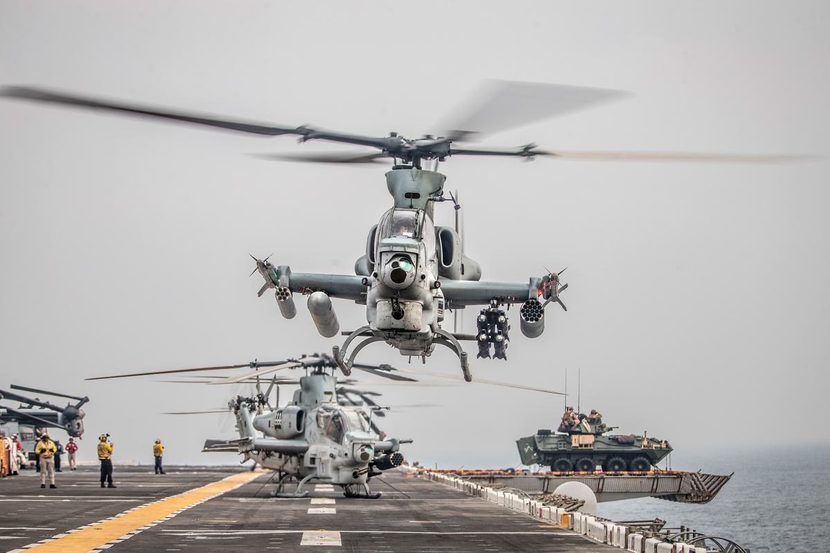 An AH-1Z Viper takes off during a strait transit aboard the amphibious assault ship USS Boxer (LHD-4)