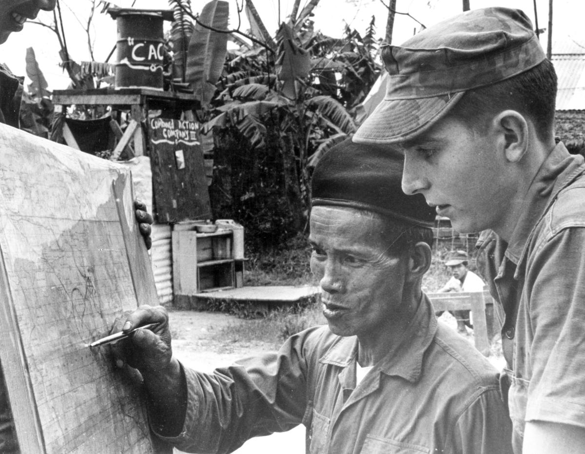 U.S. Marine Advisor speaking to his counterpart in a South Vietnamese Combined Action Platoon