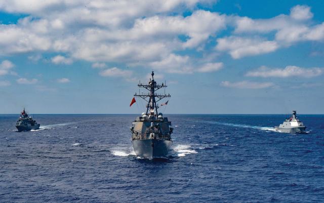 The guided-missile  destroyer USS Winston S. Churchill (DDG-81), middle, executes  a passing exercise  with the Turkish Navy frigates Barbaros and Burgazada in the  Mediterranean Sea,  26 August.