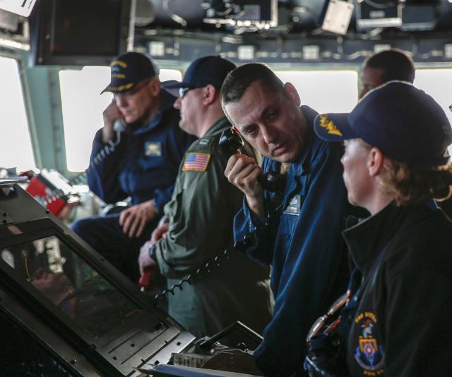 Ensign Scott Stephen, center, speaks with Cmdr. Zoe Arantz, commanding officer of the Arleigh Burke-class guided-missile destroyer USS Nitze (DDG-94), during a strait transit training event