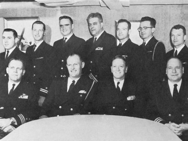 Lieutenant Commander H. J. Post (first row, far left) and the staff of Commander, Cruiser Destroyer Flotilla 9, from the USS Galveston (CL-93) 1963-64 cruise book. The Galveston patch on Maverick’s flight jacket in Top Gun likely pays homage to Post, who was commanding officer of the Navy’s first fighter weapons school.  (Naval History and Heritage Command).    
