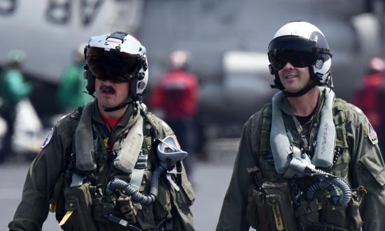 Naval aviators walk the flight deck of the aircraft carrier USS Harry S. Truman (CVN-75)