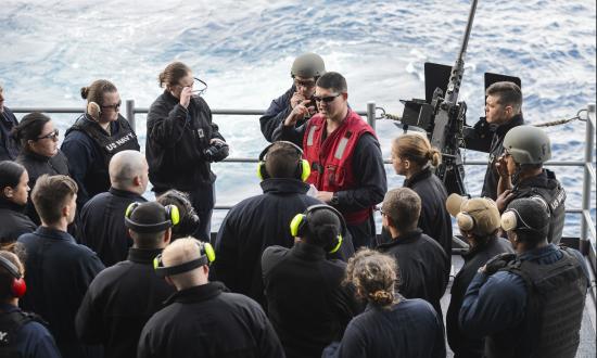 Sailors listen to a safety brief on board the USS Nimitz.