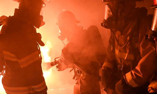 Surface Warfare Engineering Schools Command Great Lakes instructors train accession sailors in firefighting. The Navy should establish an annual firefighting physical fitness assessment for sailors assigned to afloat commands and those preparing to report to afloat commands.